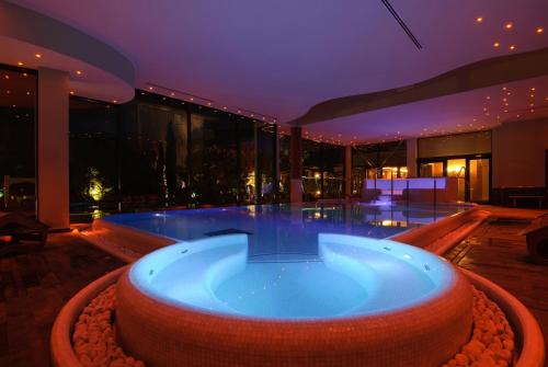 a hot tub in the middle of a building at Villa Nicolli Romantic Spa Resort - Adults Only in Riva del Garda
