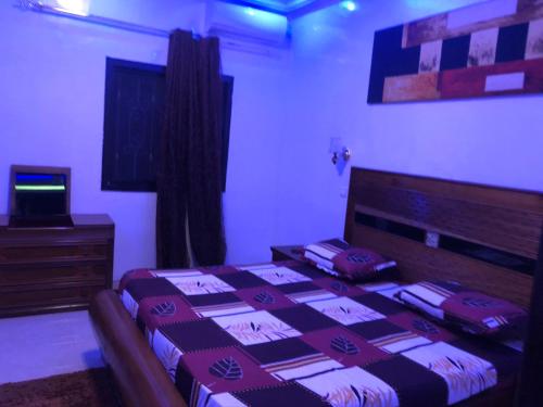 a bedroom with a bed and a television in it at Villa soleil du Sénégal in Dakar