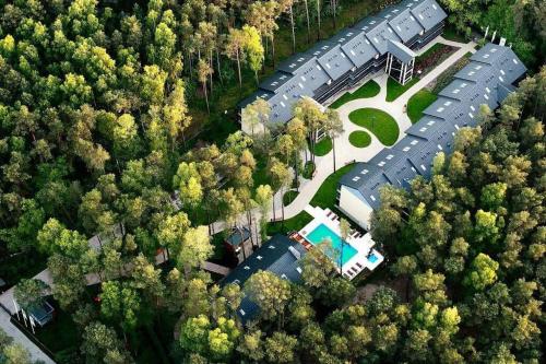 an overhead view of a house with a lot of trees at Sea&Forest Pogorzelica Apartament Platynowy in Pogorzelica