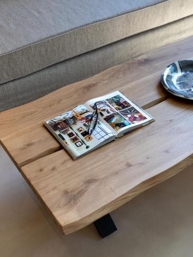 a coffee table with a magazine on top of it at Muse Urban Suites in Athens