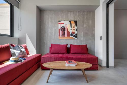 a living room with a red couch and a table at Muse Urban Suites in Athens