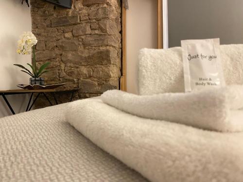 a close up of a bed with white sheets at Royal Mile Balconies by the Castle in Edinburgh