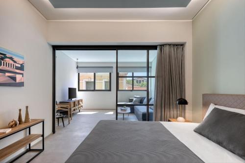 a bedroom with a bed and a desk at Muse Urban Suites in Athens