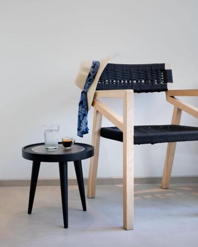 a chair and a table with a drink on it at Muse Urban Suites in Athens