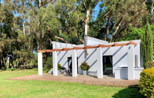 a white building with a staircase in a park at Rest at Chabivin in Stellenbosch