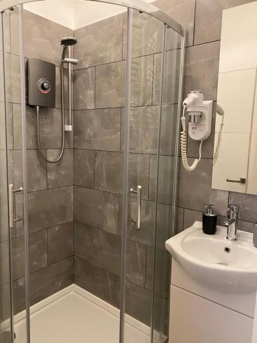a bathroom with a shower and a sink at Royal Mile Balconies by the Castle in Edinburgh