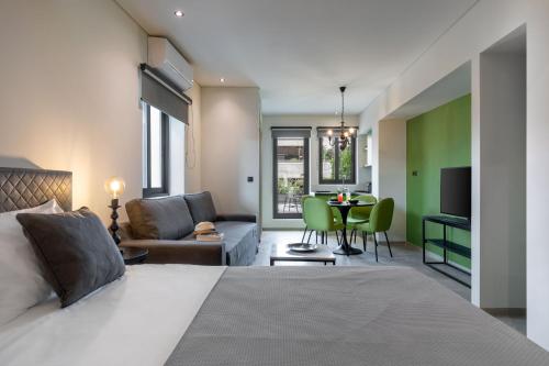 a bedroom with a bed and a living room at Muse Urban Suites in Athens