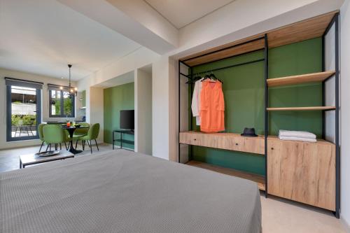 a bedroom with a bed and a table with a chair at Muse Urban Suites in Athens