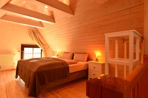 a bedroom with a bed in a wooden room at Wiekhaus 49 in Neubrandenburg
