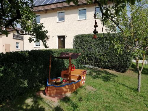 a toy train in the grass in front of a house at Ferienhaus Wagnerhof in Ahortal