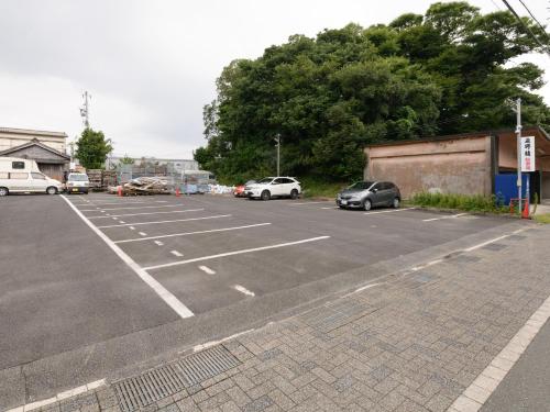 an empty parking lot with cars parked in it at Tabist Asanokan Annex Iroha Ise in Ise