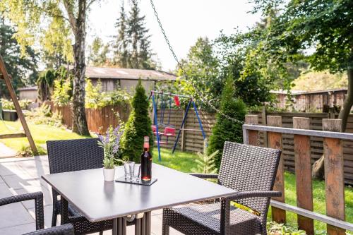 a bottle of wine sitting on a table on a patio at Ökotel Hamburg in Hamburg