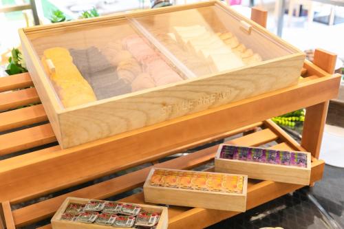 a wooden box filled with different types of cheese at Hotel Hewitt Koshien in Nishinomiya