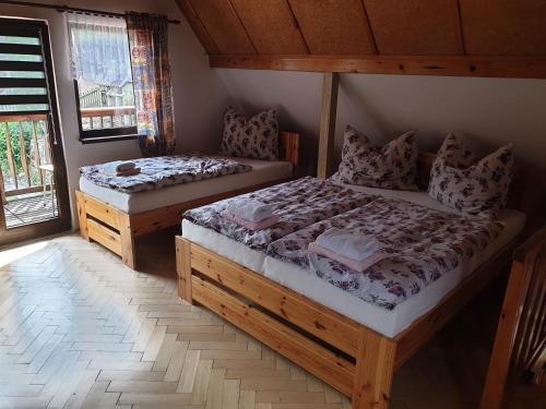 a bedroom with two beds in a cabin at Chata Seeberg in Poustka