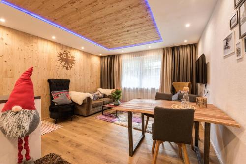 a living room with a gnome sitting on a table at Quality Hosts Arlberg - ALPtyrol Appartements in Sankt Anton am Arlberg