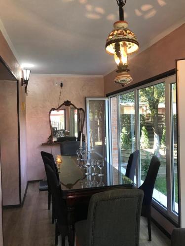 a dining room with a table with chairs and a chandelier at Sport Residence in Bacău