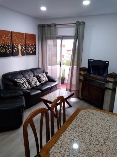 a living room with a couch and a table at Apartamento Balsa 2 in Viseu
