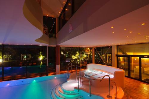a house with a swimming pool in a building at Villa Nicolli Romantic Spa Resort - Adults Only in Riva del Garda