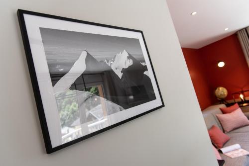a picture hanging on a wall in a living room at Résidences Alticimes in Brides-les-Bains