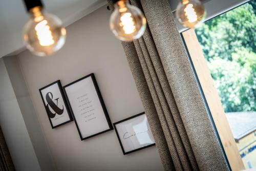 a room with a window with framed pictures and lights at Résidences Alticimes in Brides-les-Bains