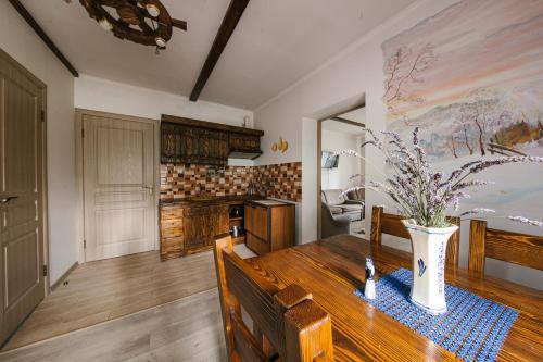 a kitchen with a wooden table with a vase on it at Урочище Rafnivskyi in Lyuta
