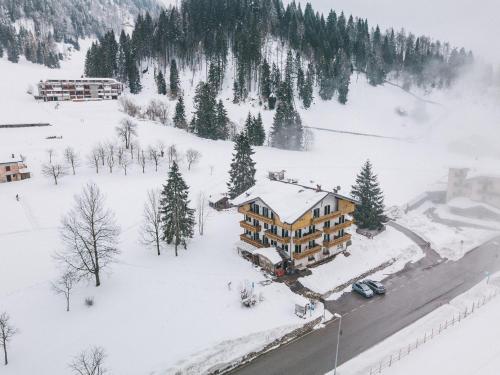 an aerial view of a lodge in the snow at Rifugio Cereda in Fiera di Primiero