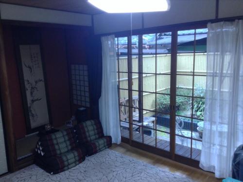 a living room with a large glass door with a window at Machiya Kyoto Shogoin in Kyoto