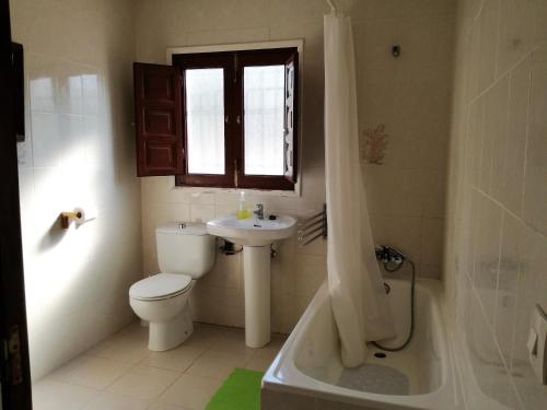 a bathroom with a toilet and a sink and a tub at Casa Olivo in Perelló