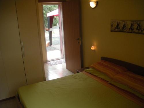 a bedroom with a bed and a sliding glass door at Casa Beatrice in Santa Margherita di Pula