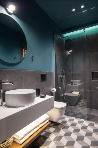 a bathroom with a tub and a sink and a shower at Λιθεία-Lithia in Ioannina