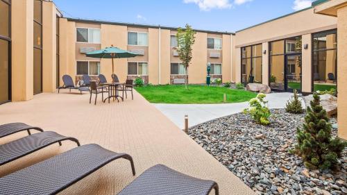 a patio area with chairs, tables, and lawn chairs at Best Western Plus GranTree Inn in Bozeman