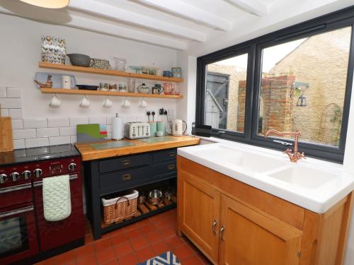 a kitchen with a sink and a window at Clementine Cottage in Darlington