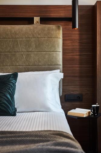 a bedroom with a bed and a book on a table at Λιθεία-Lithia in Ioannina
