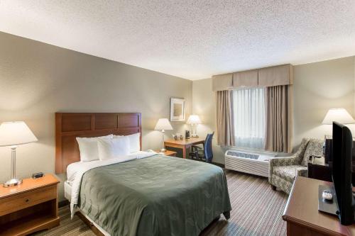 a hotel room with a bed and a television at Quality Inn in Athens