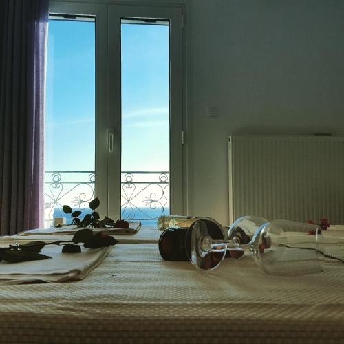 a bedroom with a bed with a view of a window at Varmy in Ierápetra