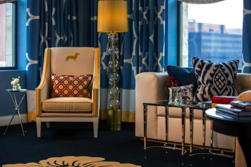 a living room with a chair and a couch at Kimpton Hotel Monaco Philadelphia by IHG in Philadelphia