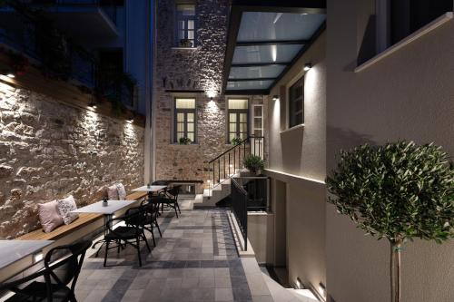 a restaurant with tables and chairs and a brick wall at Λιθεία-Lithia in Ioannina