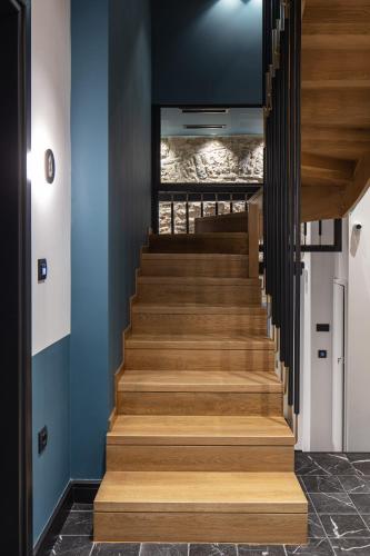 a staircase in a house with blue walls and wood at Λιθεία-Lithia in Ioannina