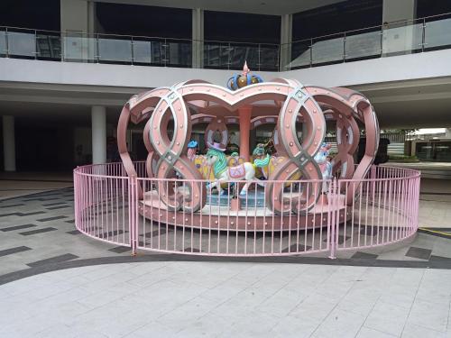 a roller coaster in front of a building at D'Gunduls Homestay STUDIO by DGH I-CITY in Shah Alam