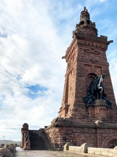 a tall brick tower with a horse statue on it at Burghof Kyffhäuser in Bad Frankenhausen