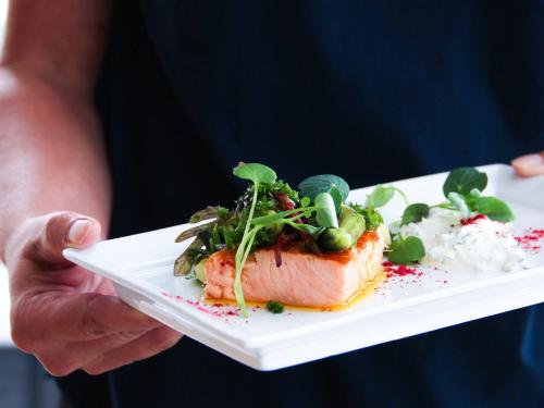 a person holding a plate with a piece of food at Hotel Faaborg Fjord in Fåborg