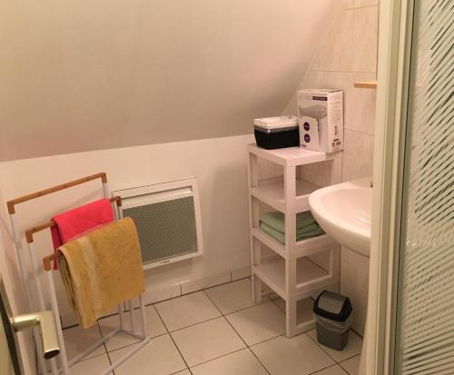 a bathroom with a sink and a towel rack at L Ecrin, duplex classé 2 étoiles, au cœur de Villandry in Villandry