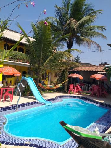 a pool at a resort with a slide at Pousada Antåpriss in Angra dos Reis