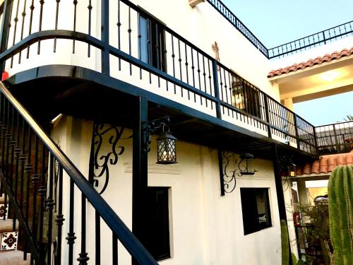 a stairway leading up to a house with a balcony at Villas del Santo Niño in Loreto