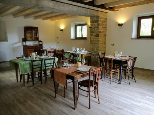 a dining room with wooden tables and chairs at Il Fienile in Selvapiana