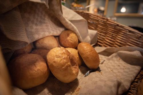 a basket filled with bread rolls on a table at Stadshotellet Kristianstad in Kristianstad