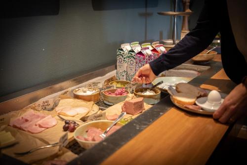 a person preparing food on a counter in a kitchen at Stadshotellet Kristianstad in Kristianstad