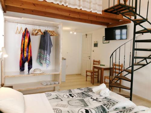 a room with a loft bed and a staircase at Aretousa Villas in Perissa