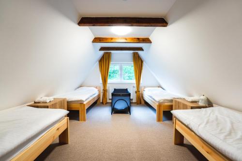 a room with three beds and a stove in it at Apartmán LYRA 