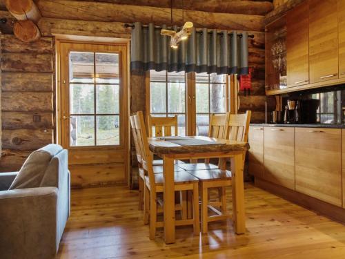 a kitchen with a table and chairs in a cabin at Holiday Home Luostakka small by Interhome in Ylläsjärvi